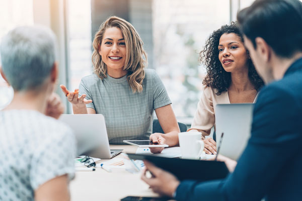 4 professionals in a meeting