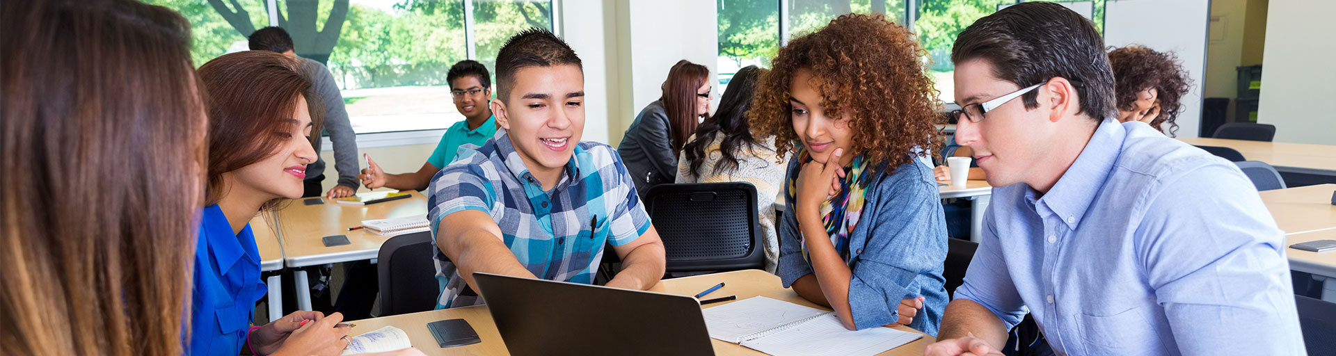 5 Students working together at a desk